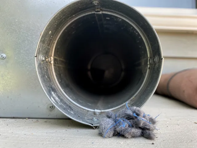Bell Dryer Vent Cleaning technician using specialized equipment to clear severe dryer vent blockage in Bell